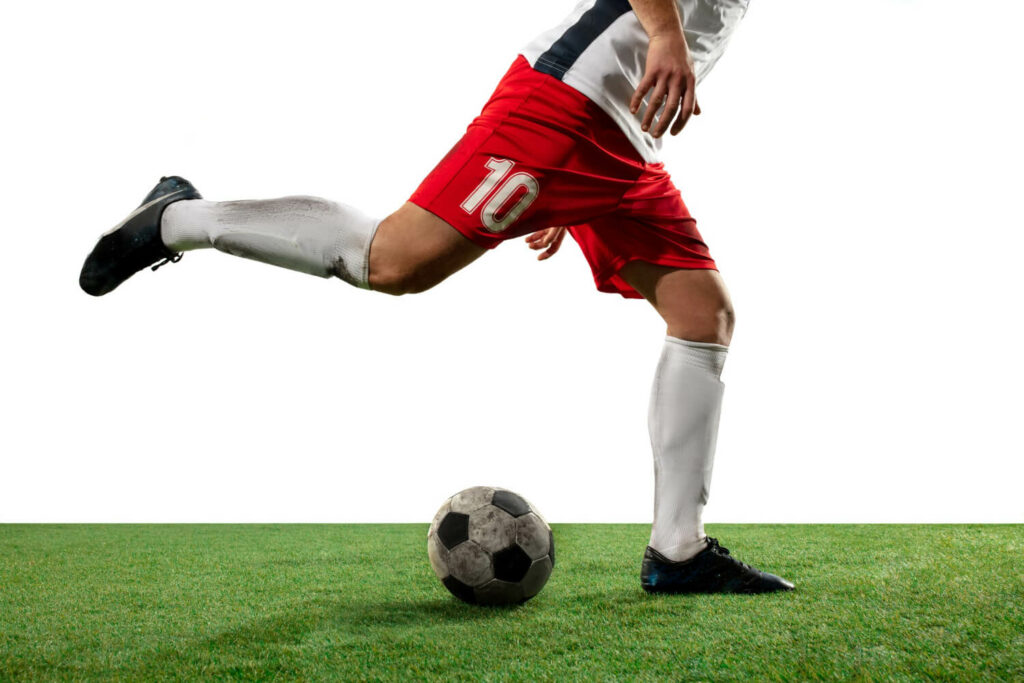 A football player kicking a ball.